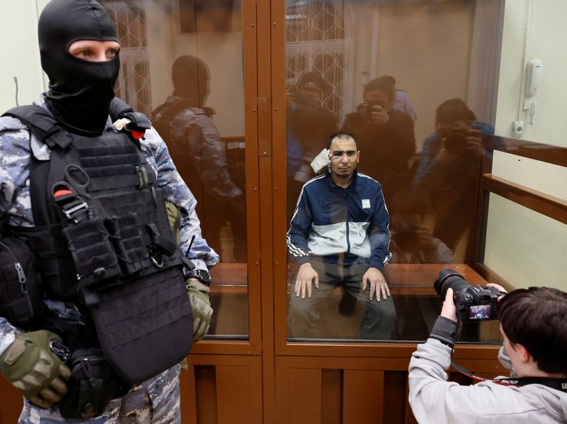 &copy; Reuters. Saidakrami Murodali Rachabalizoda, a suspect in the shooting attack at the Crocus City Hall concert venue, sits behind a glass wall of an enclosure for defendants at the Basmanny district court in Moscow, Russia March 24, 2024. REUTERS/Shamil Zhumatov