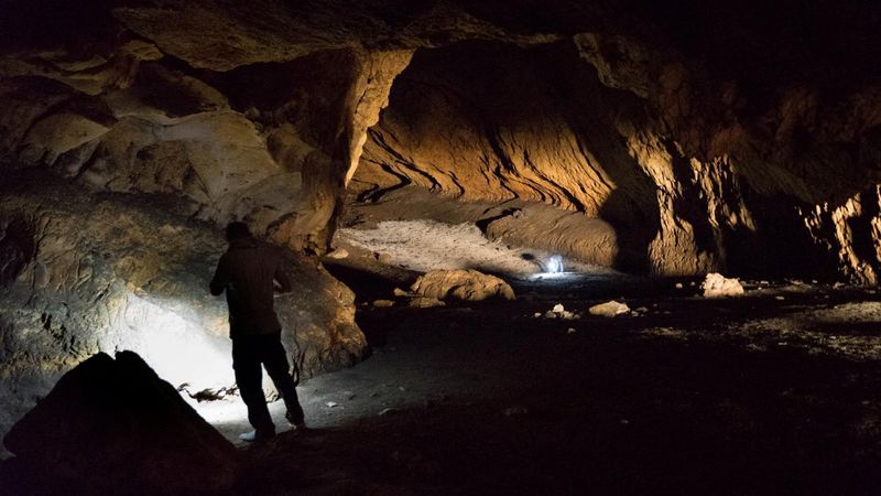 &copy; Reuters. FILE PHOTO: A person stands in Pebdeh Cave, in the southern Zagros Mountains, Iran, in this undated photo obtained by Reuters on March 25, 2024. Pebdeh Cave was occupied by hunter-gatherers as early as 42,000 years ago, inferred to be Homo Sapiens. Mohamm