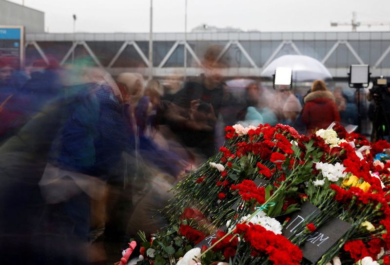 &copy; Reuters. 
Un grupo de personas deposita flores en un monumento improvisado en memoria de las víctimas de un tiroteo frente a la sala de conciertos Crocus City Hall, en la región de Moscú 
March 24, 2024. REUTERS/Maxim Shemetov  