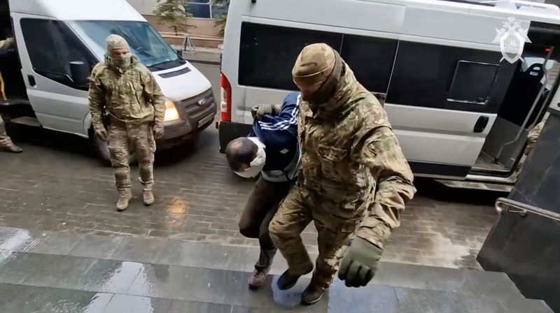 &copy; Reuters. A suspect in the Crocus City Hall shooting is escorted from a van to the Russian Investigative Committee headquarters in Moscow, Russia, in this still image taken from video released March 24, 2024. Russian Investigative Committee/Handout via REUTERS/ Fil