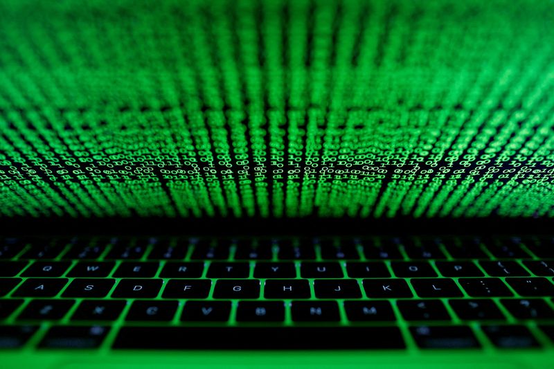 &copy; Reuters. FILE PHOTO: A computer keyboard lit by a displayed cyber code is seen in this illustration picture taken on March 1,  2017. REUTERS/Kacper Pempel/Illustration/File Photo