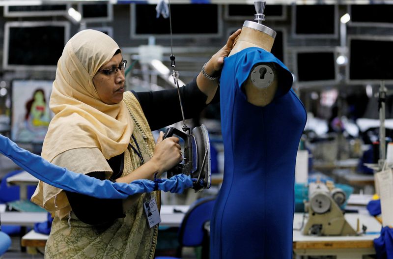 &copy; Reuters. A woman irons a dress at Timex garments factory in Wattala, Sri Lanka June 13, 2018. Picture taken June 13, 2018. REUTERS/ Dinuka Liyanawatte/ File photo