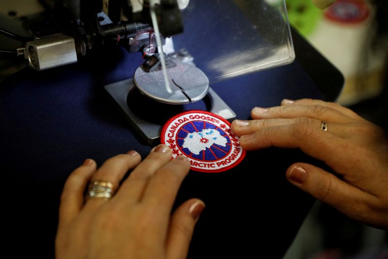 © Reuters. FILE PHOTO: A worker sews Canada Goose patches at the Canada Goose factory in Toronto, Ontario, Canada, February 23, 2018.   REUTERS/Mark Blinch/File Photo