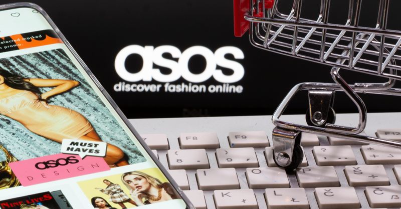 &copy; Reuters. Smartphone with ASOS app, a keyboard and a shopping cart are seen in front of a displayed ASOS logo in this illustration picture taken October 13, 2020. REUTERS/Dado Ruvic/Illustration/File Photo