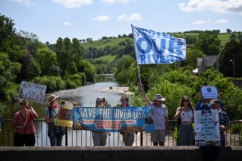 &copy; Reuters. Activists take part in a protest, organised by water charity Save The River Usk, to demonstrate against poor agricultural farming practices and the continued dumping of untreated sewage by water companies, by the River Usk in Brecon, Wales, Britain, May 2