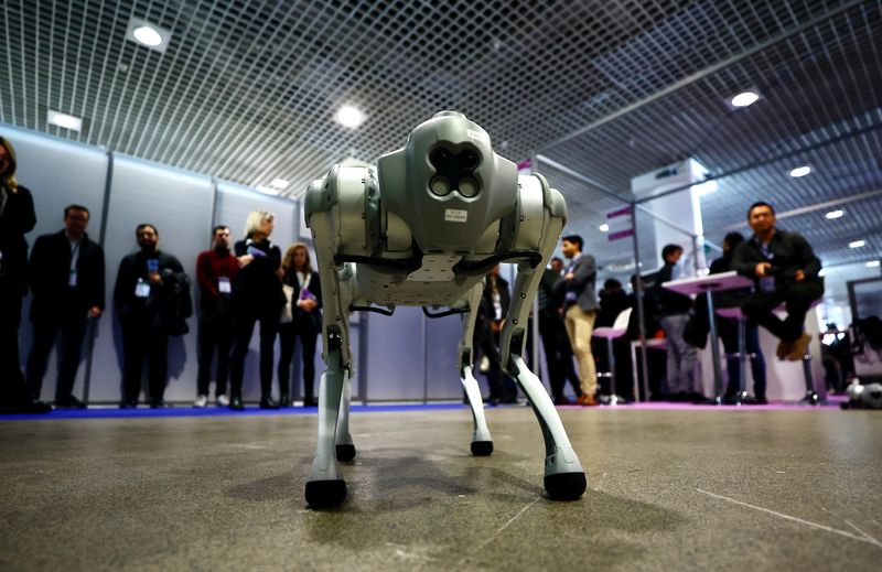 &copy; Reuters. File photo: Visitors look at a Go1 quadruped robot by Unitree Robotics during the World Artificial Intelligence Cannes Festival (WAICF) in Cannes, France, February 10, 2023.  REUTERS/Eric Gaillard/File photo