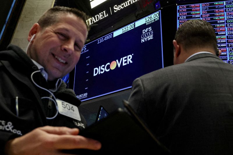 &copy; Reuters. FILE PHOTO: A screen displays the logo and trading information for  Discover Financial as traders work on the floor at the New York Stock Exchange (NYSE) in New York City, U.S., February 20, 2024.  REUTERS/Brendan McDermid/File Photo