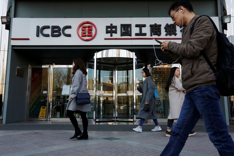 &copy; Reuters. People walk past a branch of Industrial and Commercial Bank of China (ICBC) in Beijing, China April 1, 2019. Picture taken April 1, 2019.  REUTERS/Florence Lo/File Photo