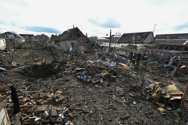 © Reuters. عمال الإنقاذ يعملون في موقع المباني السكنية التي تضررت جراء غارة روسية بطائرات مسيرة في مدينة زابوريجيا يوم الخميس. صورة لرويترز.