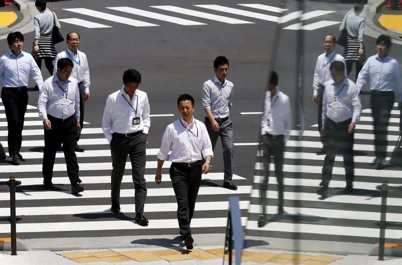 &copy; Reuters. FILE PHOTO: Office workers are reflected in a glass railing as they cross a street during lunch hour in Tokyo June 1, 2015.  REUTERS/Thomas Peter/File Photo 
