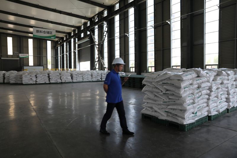 &copy; Reuters. A staff member walks inside a warehouse for fertiliser products at Syngenta Group China's Modern Agriculture Platform (MAP) service centre, during a media tour in Wei county of Handan, Hebei province, China June 11, 2021. Picture taken June 11, 2021. REUT