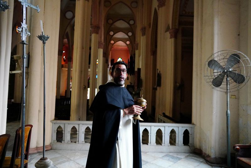&copy; Reuters. Priest Lester Zayas, 45, speaks to an assistant (not pictured) as he prepares the church for the Holy Week celebrations in Havana, Cuba, March 28, 2024. REUTERS/Alexandre Meneghini