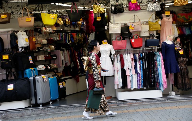 &copy; Reuters. FILE PHOTO: A woman in a kimono walks past a shop in a shopping district in Tokyo, Japan March 23, 2017. Picture taken on March 23, 2017. REUTERS/Kim Kyung-Hoon/File Photo