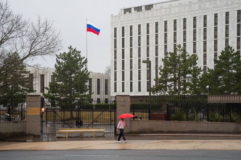 &copy; Reuters. FILE PHOTO: A pedestrian walks with an umbrella outside the Embassy of the Russian Federation, near the Glover Park neighborhood of Washington, U.S., February 22, 2022. REUTERS/Tom Brenner/File Photo
