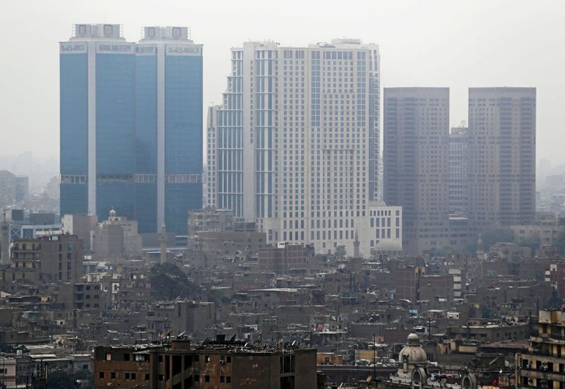 &copy; Reuters. FILE PHOTO: National Bank of Egypt head offices, the St. Regis Cairo hotel and Hilton Cairo World Trade Center Residences are seen towering above residential buildings in the downtown Cairo, Egypt, May 6, 2018. REUTERS/Mohamed Abd El Ghany/File Photo