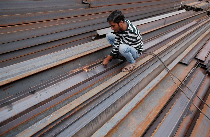 &copy; Reuters. FILE PHOTO: A worker cuts iron rods outside a workshop at an iron and steel market in an industrial area in New Delhi, India, December 12, 2017. REUTERS/Adnan Abidi/File Photo