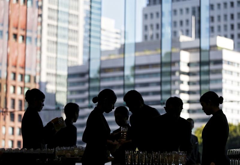 &copy; Reuters. FILE PHOTO: Butlers prepare for drinks inside a banqueting hall at a hotel in Tokyo May 21, 2015. REUTERS/Issei Kato/File Photo