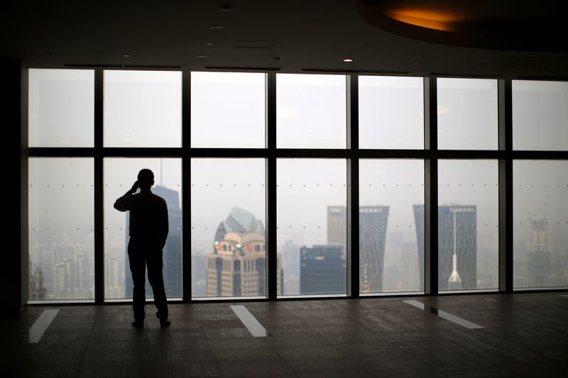&copy; Reuters. Un homme regarde la ville de Shanghai, en Chine. /Photo prise le 4 septembre 2014/REUTERS/Carlos Barria  