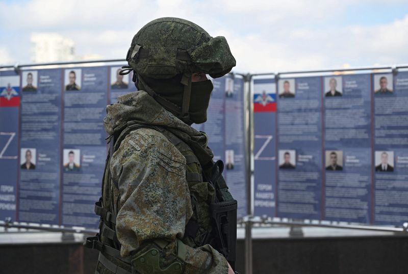 © Reuters. A Russian service member stands next to a mobile recruitment center for military service under contract in Rostov-on-Don, Russia September 17, 2022. REUTERS/Sergey Pivovarov/File Photo