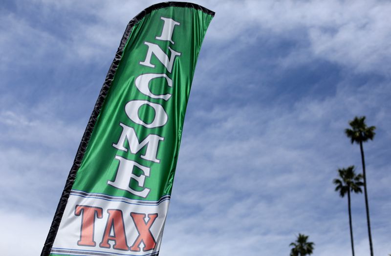 © Reuters. FILE PHOTO: A flag advertising an income tax preparation office is shown in Los Angeles, California, U.S., April 26, 2017.  REUTERS/Mike Blake/File Photo