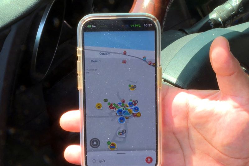 &copy; Reuters. An Israeli driver uses Waze, an Israeli mobile satellite navigation application showing his location as near Beirut in Lebanon, amid concerns of a possible escalation in violence after the killing of Iranian generals in Damascus, in Tel Aviv, Israel, Apri