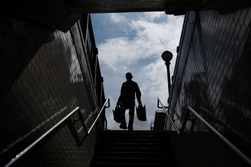 &copy; Reuters. File photo: A man is seen in silhouette as he walks with bags down a subway entrance in the Chinatown area of New York City, U.S., September 11, 2023.  REUTERS/Shannon Stapleton/File photo