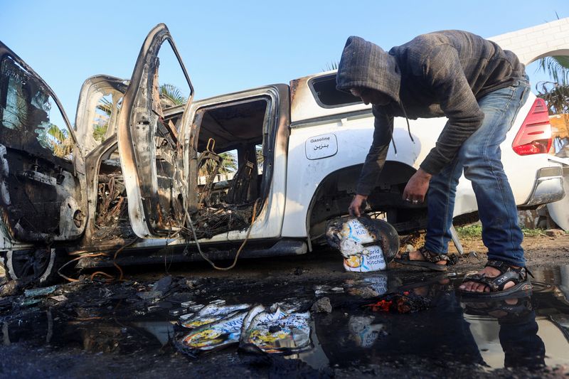 © Reuters. A Palestinian inspects near a vehicle where employees from the World Central Kitchen (WCK), including foreigners, were killed in an Israeli airstrike, according to the NGO as the Israeli military said it was conducting a thorough review at the highest levels to understand the circumstances of this 