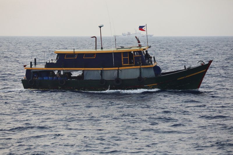 © Reuters. FILE PHOTO: A Philippine supply boat sails during a resupply mission for Filipino troops stationed at a grounded warship in the South China Sea, October 4, 2023. REUTERS/Adrian Portugal/File Photo