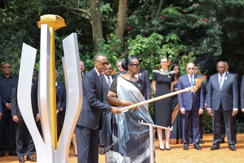 &copy; Reuters. Rwandan President Paul Kagame and First Lady Jeanette Kagame, prepare to light the Rwandan genocide flame of hope, known as the "Kwibuka" (Remembering), to commemorate the 1994 Genocide at the Kigali Genocide Memorial Center in Kigali, Rwanda April 7, 202