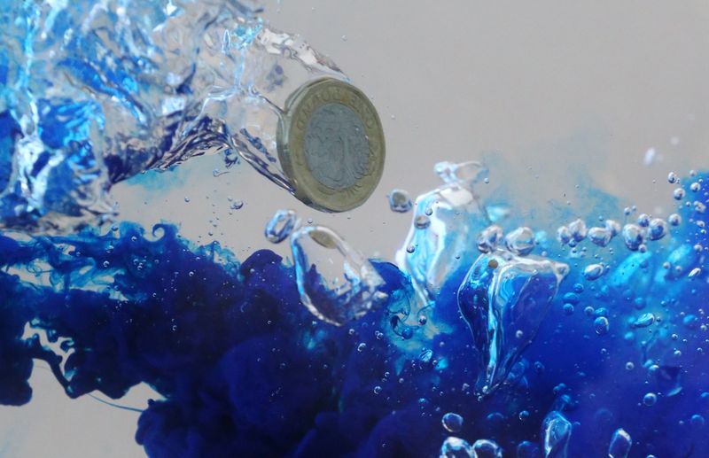 &copy; Reuters. FILE PHOTO: UK pound coin plunges into water in this illustration picture, October 26, 2017. Picture taken October 26, 2017. REUTERS/Dado Ruvic/File Photo
