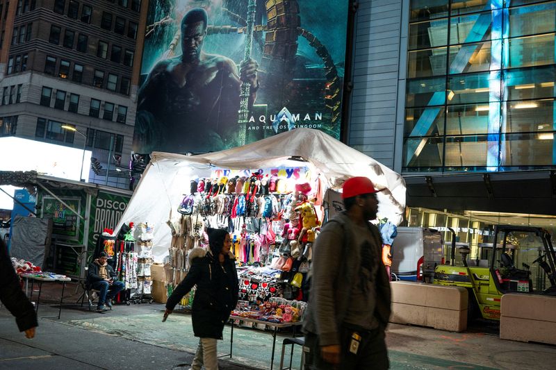 &copy; Reuters. A man waits for customers next to his makeshift tent around Times Square, in New York, U.S., December 25, 2023. REUTERS/Eduardo Munoz/File Photo