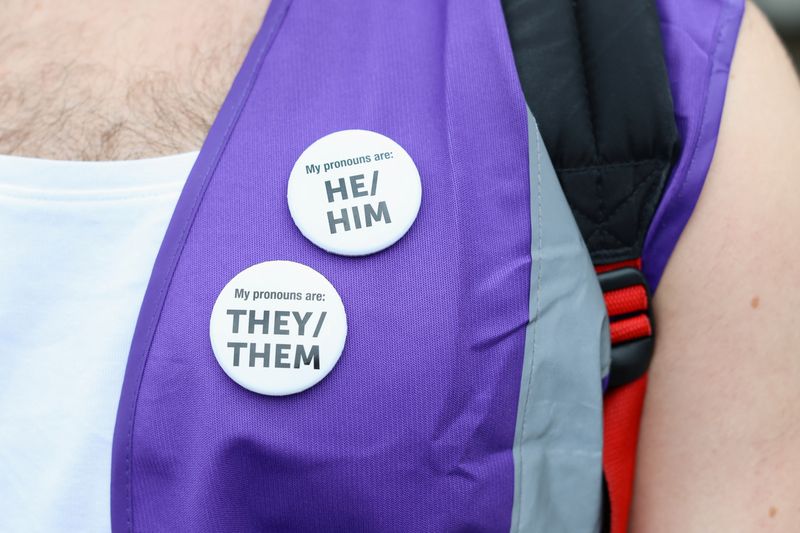 &copy; Reuters. FILE PHOTO: A person wears pins as people gather before the Trans Pride March in London, Britain, July 8, 2023. REUTERS/Anna Gordon/File Photo