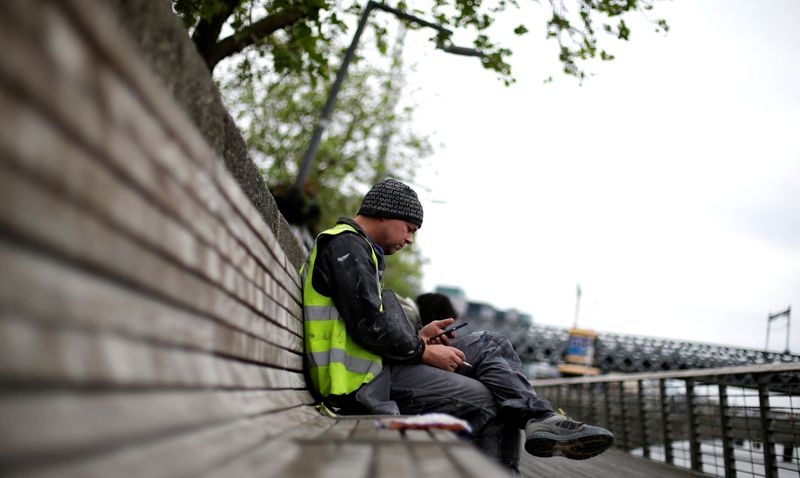 &copy; Reuters. FILE PHOTO: A man checks his phone in the city centre of Dublin, Ireland, May 22, 2018. REUTERS/Max Rossi/File Photo