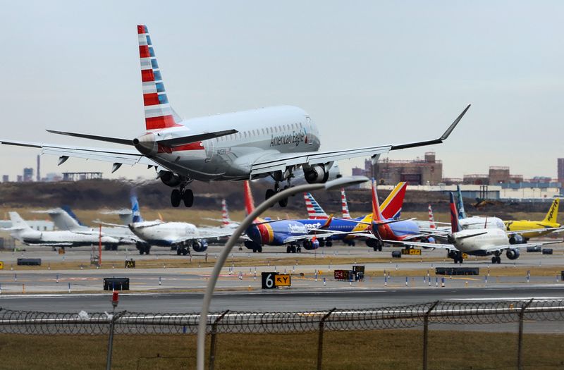&copy; Reuters. File photo: An American Airlines jet lands in front of planes backed up waiting to depart on the runway after flights earlier were grounded during an FAA system outage at Laguardia Airport in New York City, New York, U.S., January 11, 2023. REUTERS/Mike S