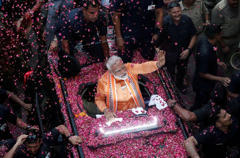 © Reuters. FILE PHOTO: India's Prime Minister Narendra Modi waves to supporters during a roadshow in Varanasi, India, April 25, 2019. Varanasi is Modi’s election constituency. REUTERS/Adnan Abidi/File Photo