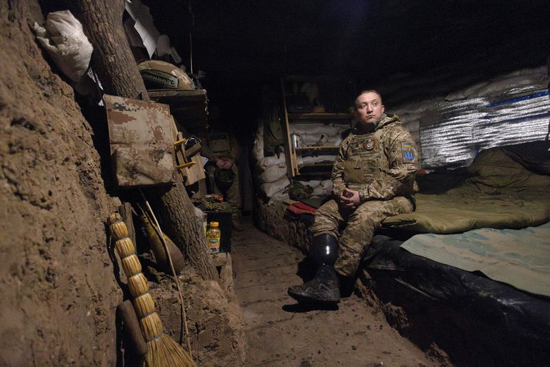 © Reuters. Odin sits in a dugout at a mortar position, in Ukraine's Donetsk region, January 26, 2024. REUTERS/Thomas Peter