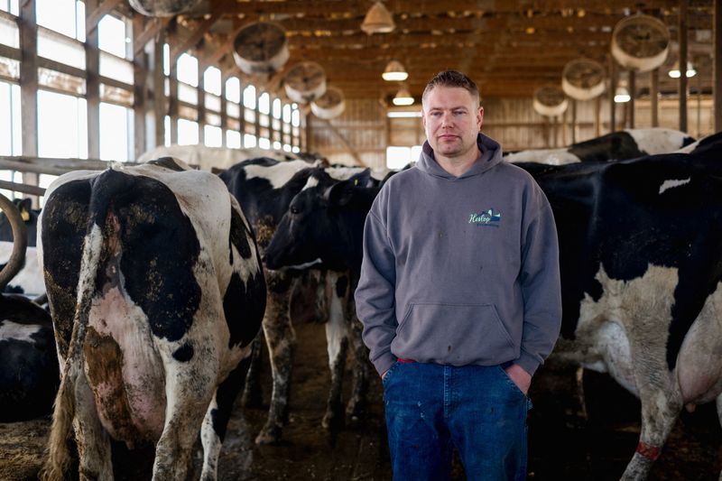 &copy; Reuters. Dairy farmer Brent Pollard stands for a portrait inside of a cow pen at his farm in Rockford, Illinois, U.S., April 9, 2024.  REUTERS/Jim Vondruska