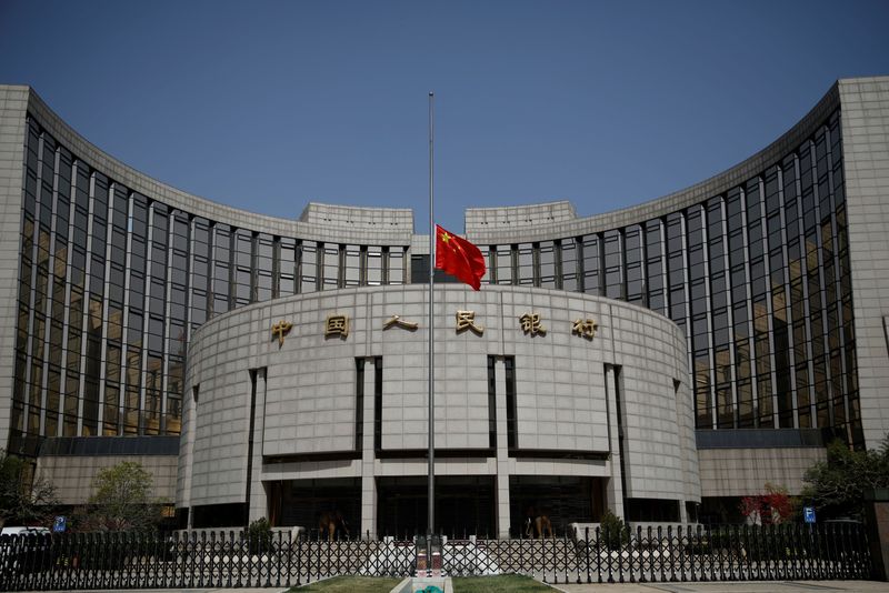 &copy; Reuters. FILE PHOTO: The Chinese national flag flies at half-mast at the headquarters of the People's Bank of China, the central bank (PBOC), as China holds a national mourning for those who died of the coronavirus disease (COVID-19), on the Qingming tomb-sweeping