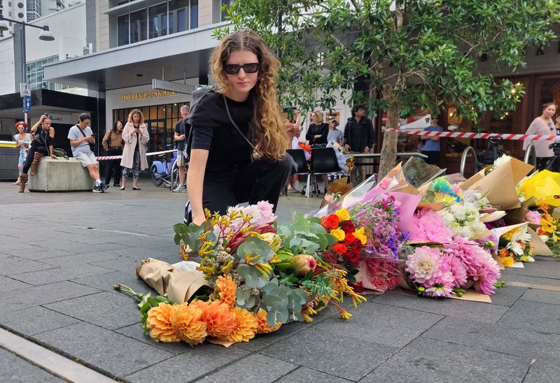 © Reuters. A woman offers flowers for the victims of Saturday's stabbings at Bondi Junction in Sydney, Australia, April 14, 2024. REUTERS/Alasdair Pal