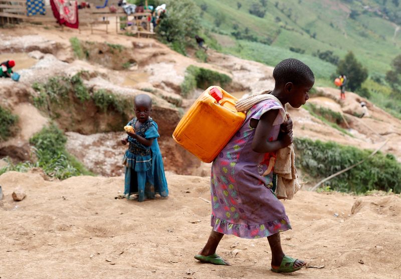 &copy; Reuters. FILE PHOTO: A girl carries a container of water at a coltan mine in Kamatare, Masisi territory, North Kivu Province of Democratic Republic of Congo, December 1, 2018.  REUTERS/Goran Tomasevic/File Photo