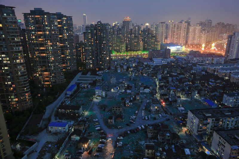 &copy; Reuters. FILE PHOTO: A night view of the old houses surrounded by new apartment buildings at Guangfuli neighbourhood in Shanghai, China, April 10, 2016. REUTERS/Aly Song/File Photo