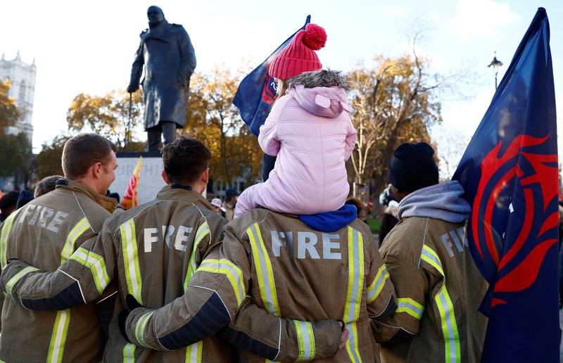 &copy; Reuters. Members of the Fire Brigades Union, taking part in a rally regarding possible future strike action linked to a pay dispute, pose for a photograph near to a statue of Winston Churchill, in London, Britain, December 6, 2022.  REUTERS/Peter Nicholls/ File ph