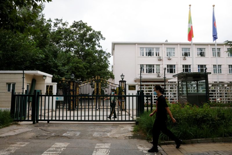 © Reuters. A man walks past a paramilitary police officer keeping watch outside the Myanmar embassy in Beijing, China August 8, 2022. REUTERS/Carlos Garcia Rawlins/File Photo