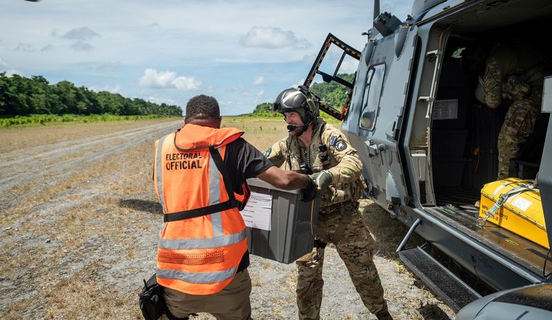 &copy; Reuters. FILE PHOTO: Members of the New Zealand Defence Force (NZDF) Joint Task Force assist in delivering ballot boxes by NH90 helicopter to remote areas of the Solomon Islands ahead of the upcoming election, Solomon Islands, in this handout image released on Apr