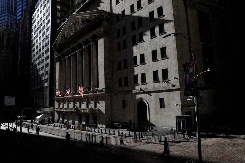 © Reuters. FILE PHOTO: The New York Stock Exchange (NYSE) is seen as people walk in silhouette in the financial district of New York, U.S., November 19, 2020. REUTERS/Shannon Stapleton/File Photo