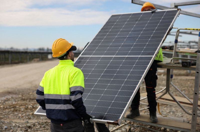 &copy; Reuters. FILE PHOTO: Two workers install a bifacial 540 W solar panel at a solar panels park by energy supplier Enel Green Power, in Trino Italy, March 5, 2024. REUTERS/Claudia Greco/File Photo
