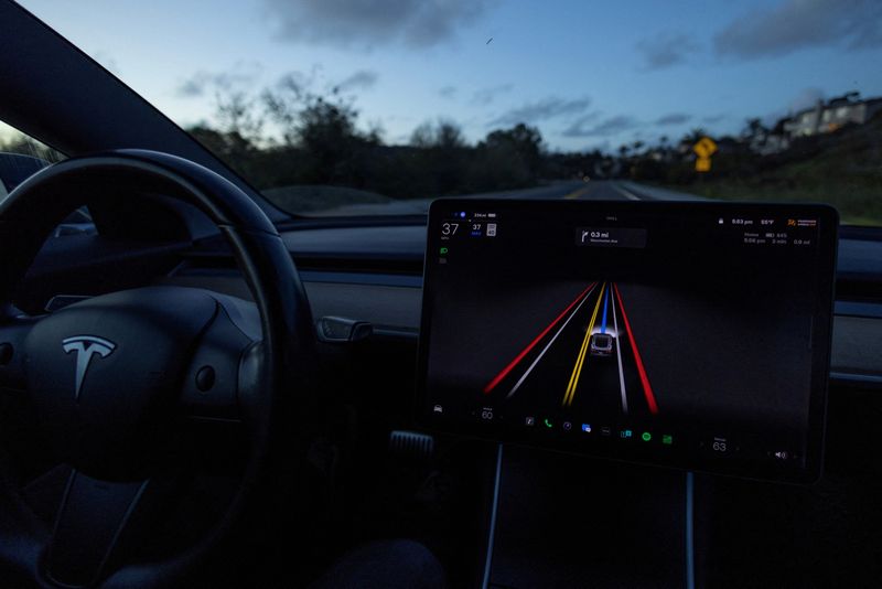 © Reuters. A Tesla Model 3 vehicle is shown using the Full Self Driving Beta software (FSD) while navigating a city road in Encinitas, California, U.S., February 28, 2023. REUTERS/Mike Blake/File Photo
