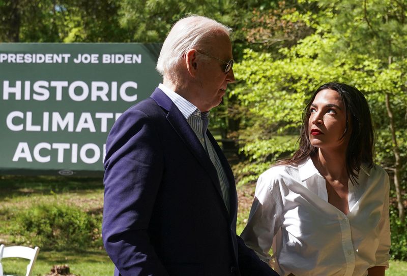 &copy; Reuters. U.S. President Joe Biden and U.S. Representative Alexandria Ocasio-Cortez (D-NY) walk together at an event to commemorate Earth Day during a visit to Prince William Forest Park in Triangle, Virginia, U.S., April 22, 2024.  REUTERS/Kevin Lamarque