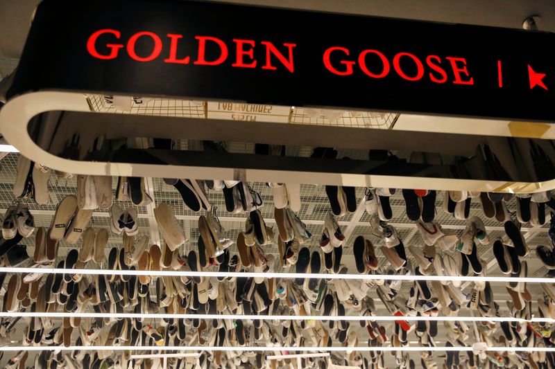 &copy; Reuters. FILE PHOTO: Sneakers of Italian high fashion sneaker brand Golden Goose are hung near its sign at its store in Beijing, China September 23, 2020. Picture taken September 23, 2020. REUTERS/Tingshu Wang/File Photo