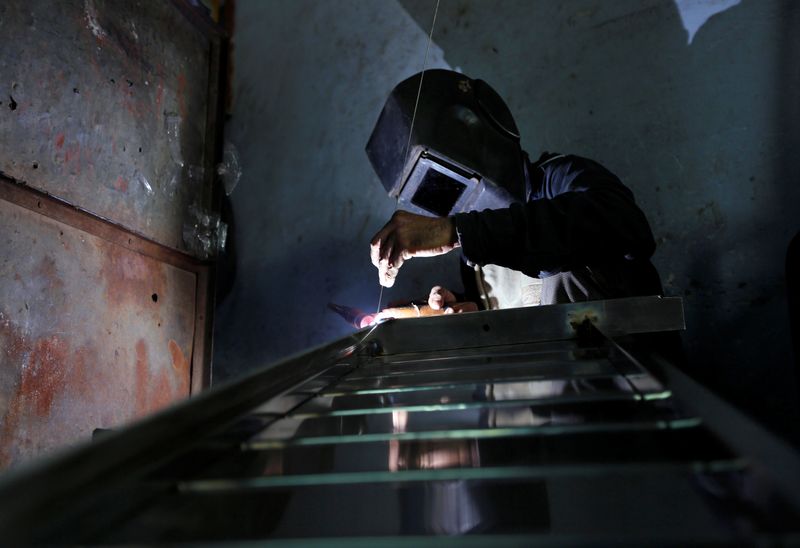 &copy; Reuters. FILE PHOTO: A worker welds steel pipes to make a counter at a steel furniture manufacturing unit in Ahmedabad, India September 1, 2016. REUTERS/Amit Dave/File Photo